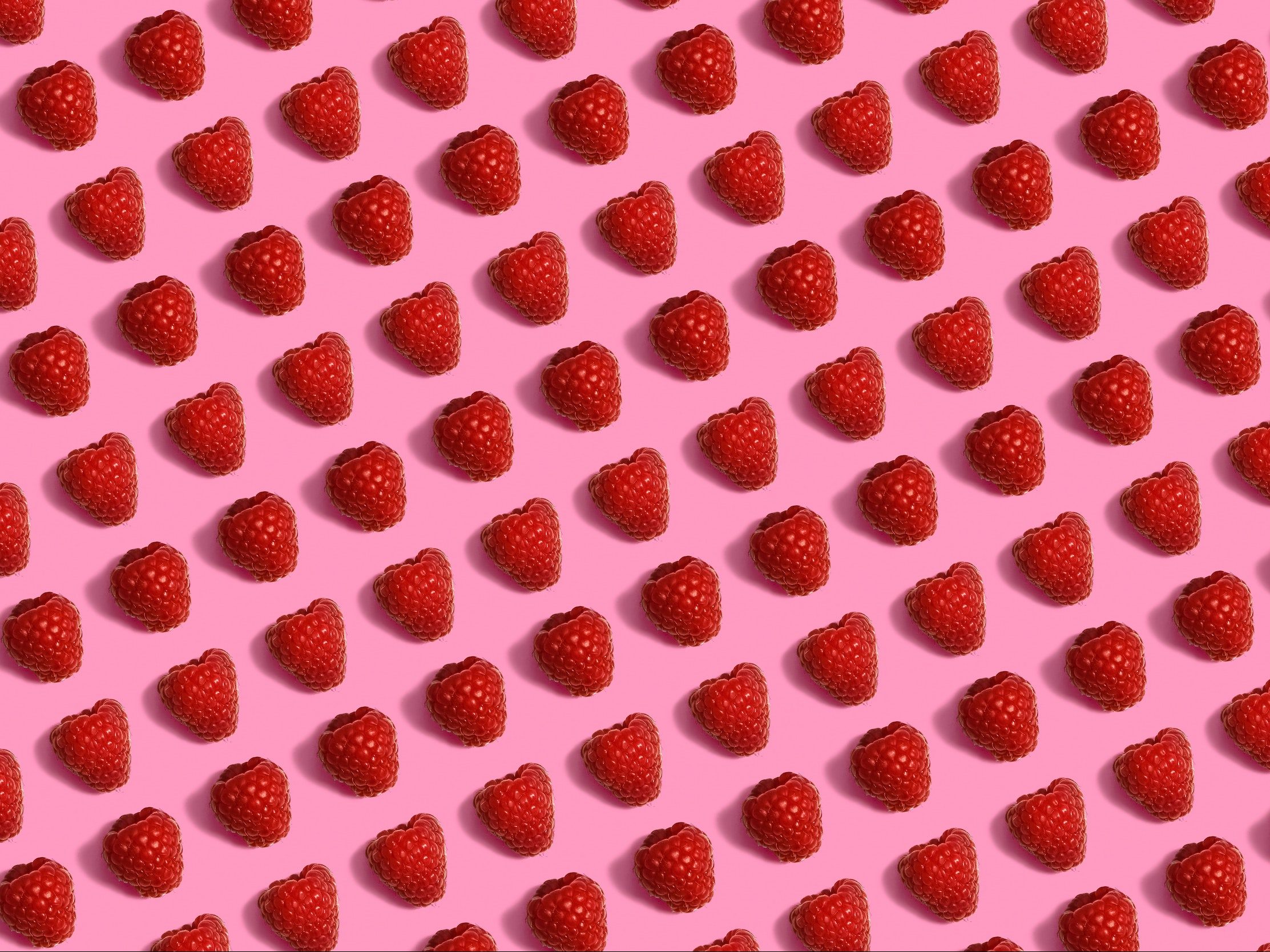 Raspberries on pink background